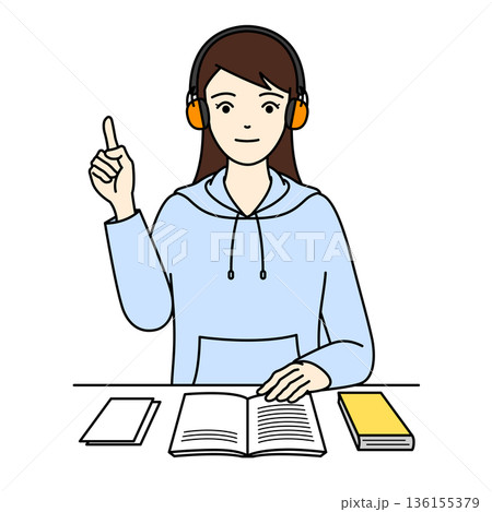 聴覚過敏用のイヤーマフを付けて勉強中にポイントを指差す集中した女性 聴覚過敏用のイヤーマフを付けて勉強中にポイントを指差す集中した女性 136155379