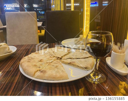 georgian traditional cuisine. plate of kubdari and wine on the table georgian traditional cuisine. plate of kubdari and wine on the table 136155885