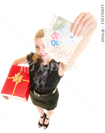 Woman with gift box and euro currency money banknotes. Woman with gift box and euro currency money banknotes. 136156823