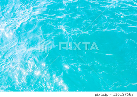 Abstract texture of turquoise sea water with light reflections. Natural background for summer, travel and nature concepts Abstract texture of turquoise sea water with light reflections. Natural background for summer, travel and nature concepts 136157568