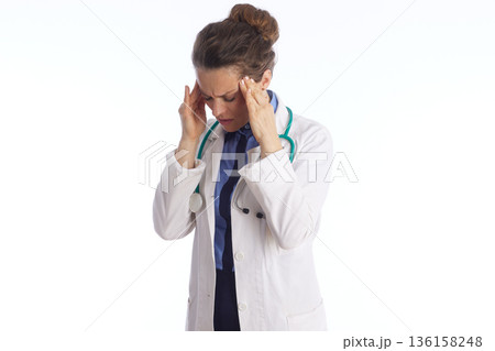 Overworked Healthcare Professional with Migraine 136158248