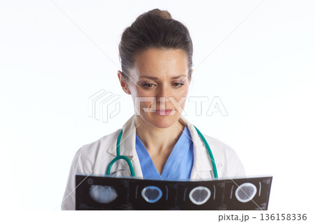 Female Doctor Analyzing Multiple X-ray Films 136158336