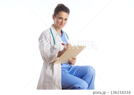 Female Physician Documenting Patient Medical Information 136158338