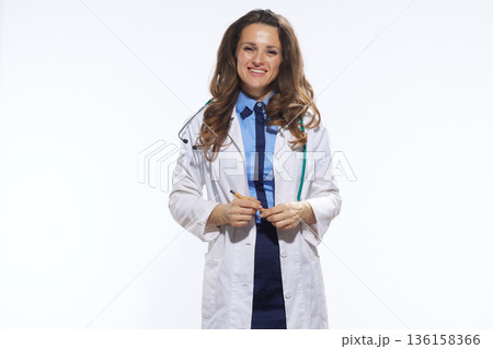 Female Doctor with Pen and Stethoscope Ready to Consult 136158366