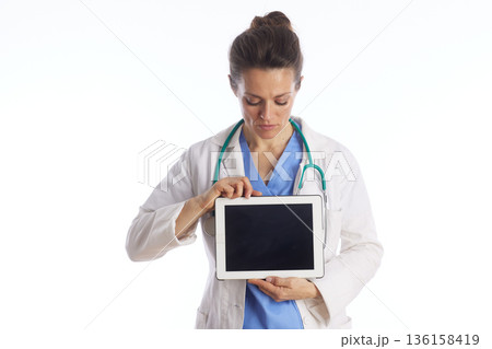 Focused Doctor Reviewing Medical Records on Tablet Focused Doctor Reviewing Medical Records on Tablet 136158419