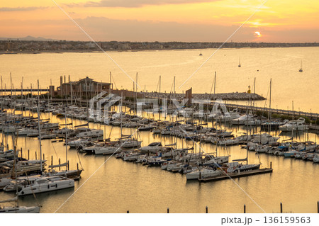 Calm on the coast. Seaport of the Italian city of Rimini in Summer Italy 136159563