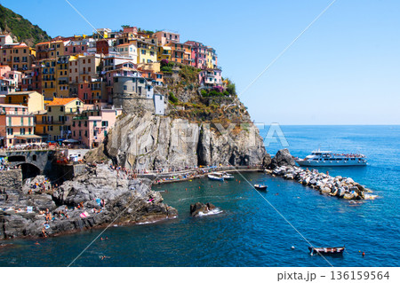 Multicolor houses on mountain. Manarola Italian village Cinque Terre Liguria Italy. Summer sea 136159564