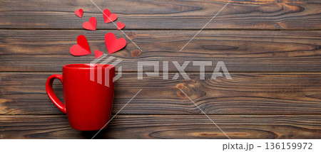 red cup on colored background, splashes of red little hearts, top view with copy space red cup on colored background, splashes of red little hearts, top view with copy space 136159972