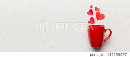 red cup on colored background, splashes of red little hearts, top view with copy space red cup on colored background, splashes of red little hearts, top view with copy space 136159977