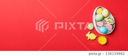 Colorful easter cookies in basket with Multi colors Easter eggs on colored background . Pastel color Easter eggs. holiday concept with copy space Colorful easter cookies in basket with Multi colors Easter eggs on colored background . Pastel color Easter eggs. holiday concept with copy space 136159982