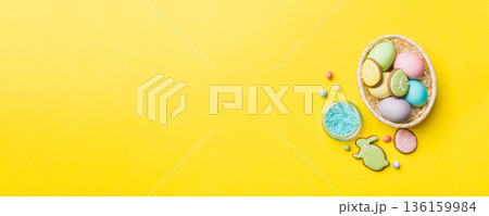 holiday preparation Multi colors Easter eggs with cookies on colored background . Pastel color Easter eggs. holiday concept with copy space 136159984