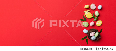 Colorful easter eggs in nest on table background with copy space top view Colorful easter eggs in nest on table background with copy space top view 136160023