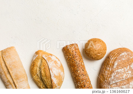 Homemade natural breads. Different kinds of fresh bread as background, top view with copy space Homemade natural breads. Different kinds of fresh bread as background, top view with copy space 136160027