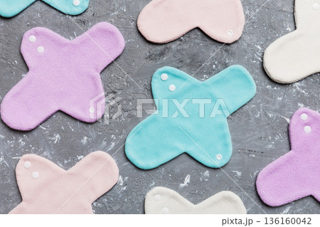 Eco-friendly reusable fabric women's pads. set of colorful bright reusable menstrual pads. zero waste woman periods concept top view with copy space 136160042