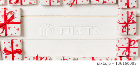 Valentine background - many valentine handmade present gift boxes on wooden background. top view with copy space. holiday concept Valentine background - many valentine handmade present gift boxes on wooden background. top view with copy space. holiday concept 136160085