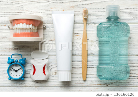 Mouthwash and other oral hygiene products on colored table top view with copy space. Flat lay. Dental hygiene. Oral care kit. Dentist concept Mouthwash and other oral hygiene products on colored table top view with copy space. Flat lay. Dental hygiene. Oral care kit. Dentist concept 136160126