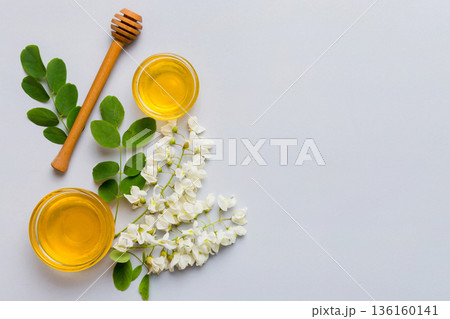 honey jar with acacia flowers and leaves. fresh honey top view flat lay 136160141