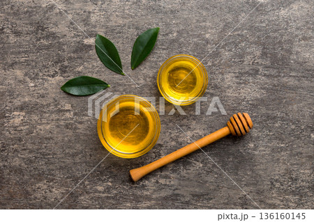 Honey jar with wooden honey dipper on white background top view with copy space. Delicious honey bottle Honey jar with wooden honey dipper on white background top view with copy space. Delicious honey bottle 136160145