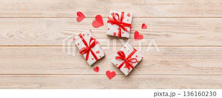 Valentine day composition Background: red gift box with bow and heart. Christmas present. View from above. Holday greeting card 136160230