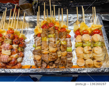 Asian skewers with meat, vegetables and fruits 136160287