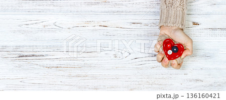 Hands of a woman squeezing a heart. broken love concept. Love concept with copyspace 136160421
