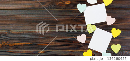 Empty paper over wooden background with colorful heart on valentines day Empty paper over wooden background with colorful heart on valentines day 136160425