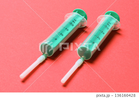 Top view of medical syringes on colorful background with copy space. Injection equipment concept Top view of medical syringes on colorful background with copy space. Injection equipment concept 136160428