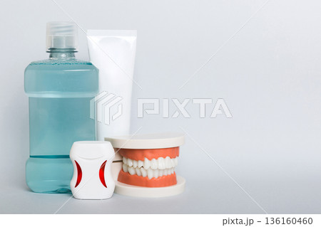 Mouthwash and other oral hygiene products on colored table top view with copy space. Flat lay. Dental hygiene. Oral care kit. Dentist concept 136160460