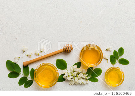 honey jar with acacia flowers and leaves. fresh honey top view flat lay 136160469