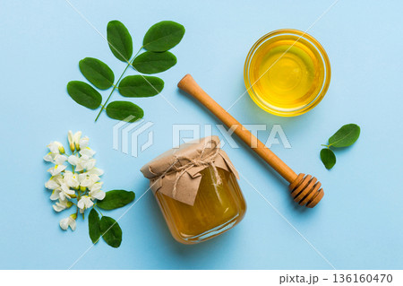 honey jar with acacia flowers and leaves. fresh honey top view flat lay 136160470