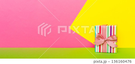 holiday paper present tied pink ribbon bow top view with copy space. Flat lay holiday background. Birthday or christmas present. Christmas gift box concept with copy space holiday paper present tied pink ribbon bow top view with copy space. Flat lay holiday background. Birthday or christmas present. Christmas gift box concept with copy space 136160476