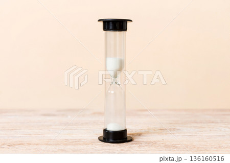 hourglass on the table, sand clock as time passing concept for business deadline, copy space hourglass on the table, sand clock as time passing concept for business deadline, copy space 136160516