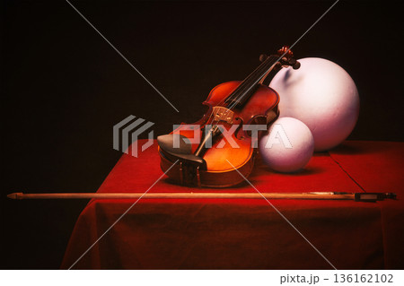 Still life with a violin and bow on a table 136162102
