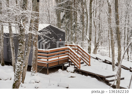 Inviting Winter Porch With Snowladen Features, Warmly Lit Outdoor Area Surrounded By Snow And Tall Birches Inviting Winter Porch With Snowladen Features, Warmly Lit Outdoor Area Surrounded By Snow And Tall Birches 136162210