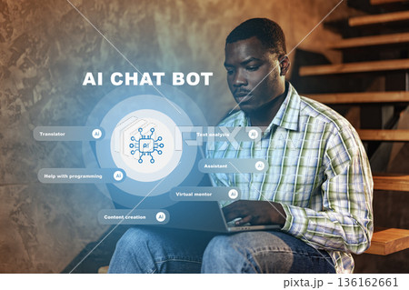 Man uses laptop to interact with AI chat bot on wooden stairs in a modern space 136162661