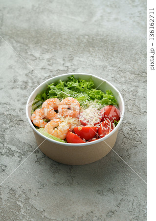 Shrimp salad with lettuce and tomatoes served in a bowl on a gray surface Shrimp salad with lettuce and tomatoes served in a bowl on a gray surface 136162711