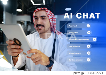 Man uses tablet to engage in AI chat and explore various features at a modern workspace 136162721