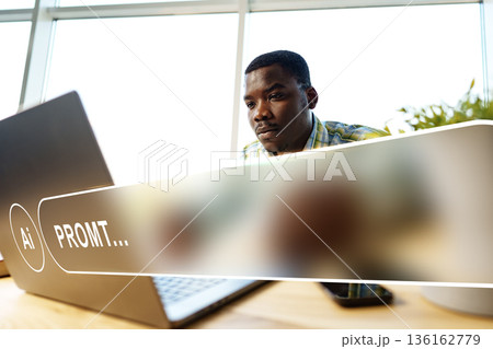 Man working on laptop with artificial intelligence prompt in office during daytime Man working on laptop with artificial intelligence prompt in office during daytime 136162779