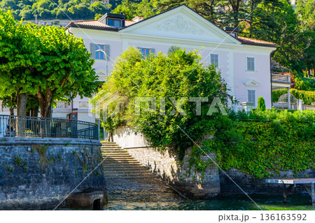 Steps - a launch for boats. Villa houses building architecture on lake Como Italy city on water Steps - a launch for boats. Villa houses building architecture on lake Como Italy city on water 136163592