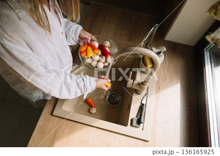 Preparing fresh vegetables in a kitchen sink for a healthy meal 136165925