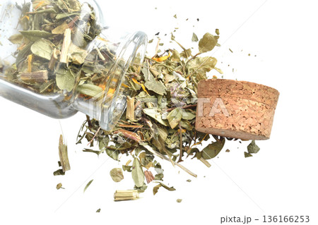 Dry herbal tea leaves in a square bottle. 136166253