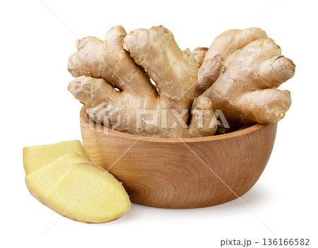 Ginger root in a wooden plate on a white background. Isolated Ginger root in a wooden plate on a white background. Isolated 136166582