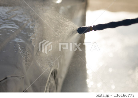 Worker washing car at self-service car wash Worker washing car at self-service car wash 136166775