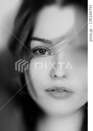 Woman's melancholic gaze, feeling pensive and thoughtful 136166791