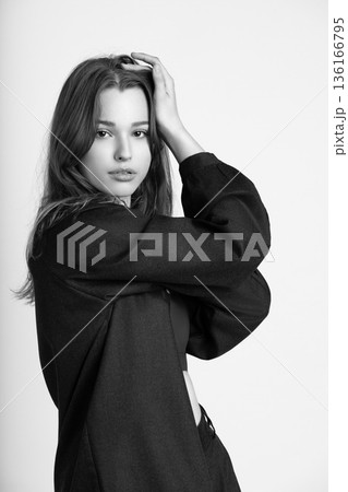 Young woman posing with hands in hair Young woman posing with hands in hair 136166795