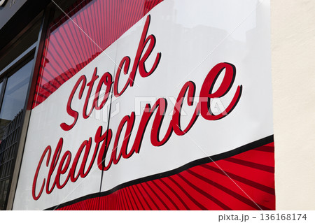 Red stock clearance sign on a retail store window 136168174