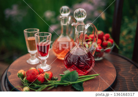 Strawberry Liqueur in Elegant Glass Decanters Outdoors Strawberry Liqueur in Elegant Glass Decanters Outdoors 136168317