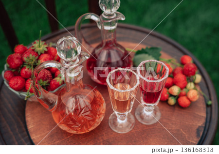 Strawberry Liqueur in Elegant Glass Decanters Outdoors 136168318