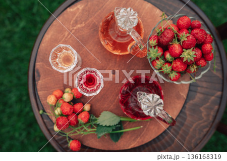 Strawberry Liqueur in Elegant Glass Decanters Outdoors 136168319
