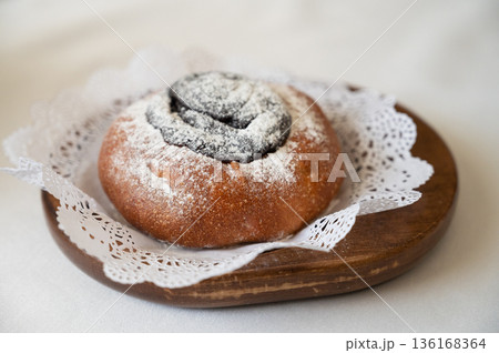 Poppy seed bun with powdered sugar Poppy seed bun with powdered sugar 136168364